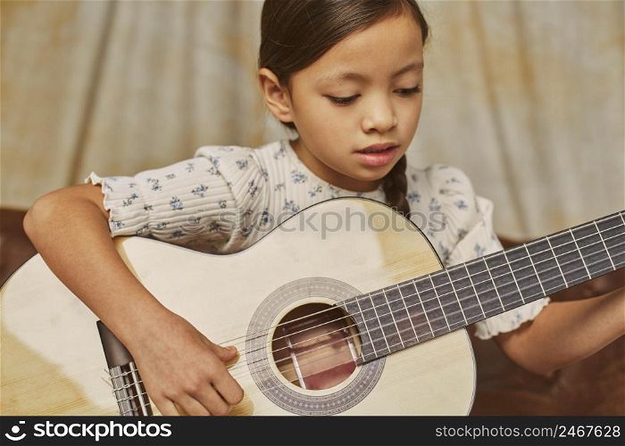 little girl learning how play guitar home 4