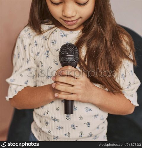 little girl learning how sing home with microphone 2