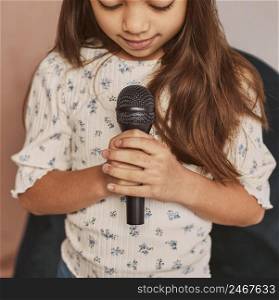 little girl learning how sing home with microphone 2
