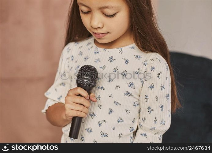 little girl learning how sing home with microphone 3