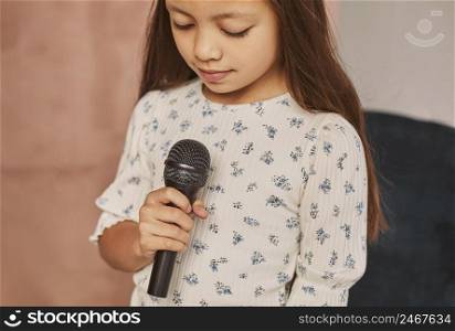 little girl learning how sing home with microphone 3