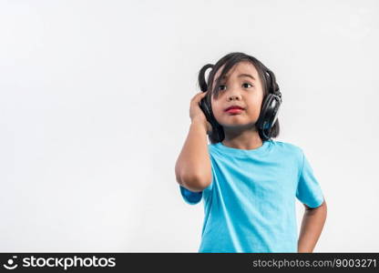 Little girl listening to music on wireless headphones 