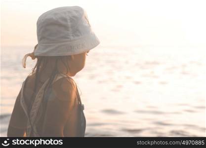 Little Girl Looking At The Sea At Sunset