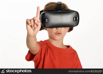 Little girl looking in VR glasses and gesturing with his hands. Cheerful surprised child wearing virtual reality goggles watching movies or playing video games, isolated on white background.