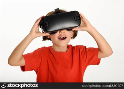 Little girl looking in VR glasses and gesturing with his hands. Cheerful surprised child wearing virtual reality goggles watching movies or playing video games, isolated on white background.