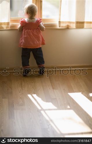 Little girl looking out of the window