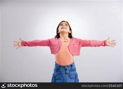 Little girl looking up with both arms open