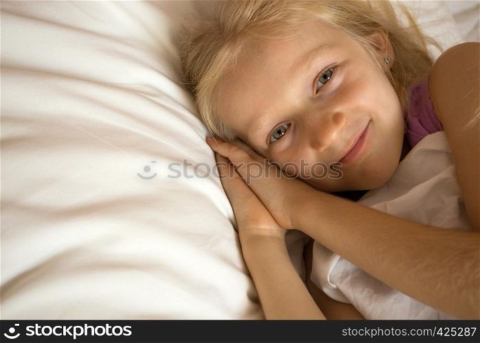 little girl lying in bed