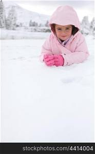 Little girl lying in the snow