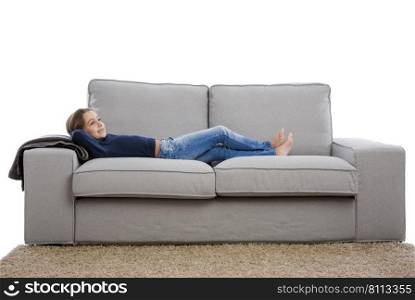 Little girl lying on a couch and resting