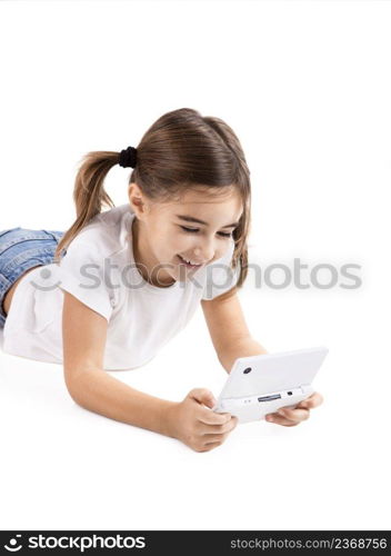 Little girl lying on floor playing a video-game