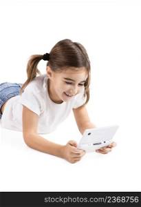 Little girl lying on floor playing a video-game