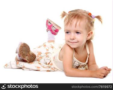 Little girl lying on her stomach on the white background
