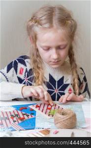 little girl make a New Year's card, scrapbook