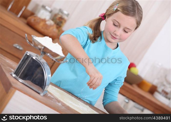 little girl making pancakes