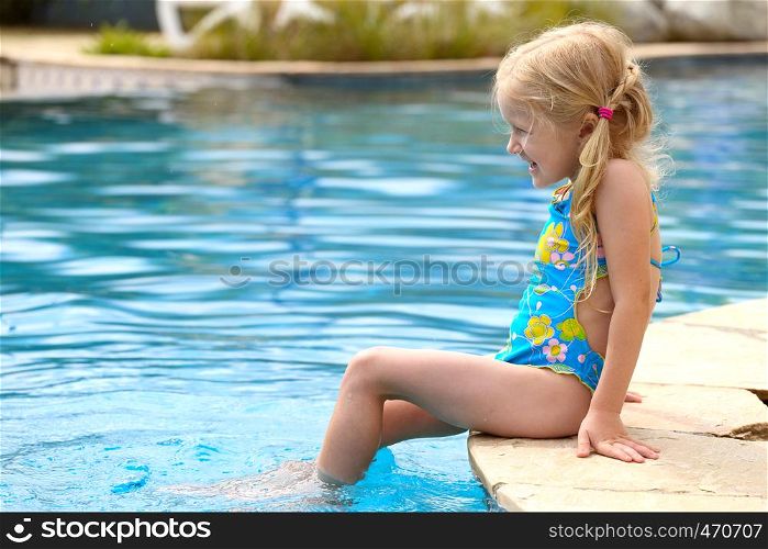 little girl near the open-air swimming pool