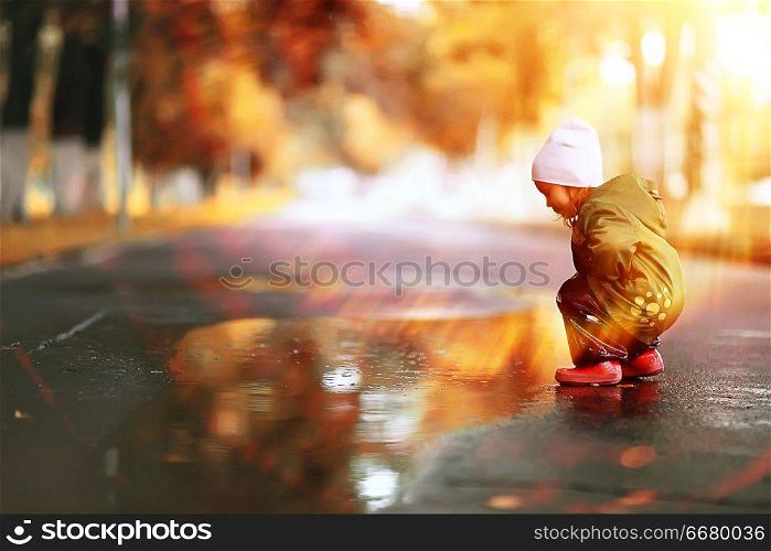 little girl on an autumn walk in the park