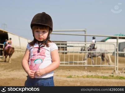 Little girl on the horse ranch