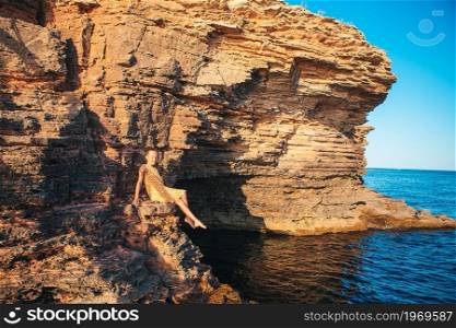 Little girl on vacation on rocks at the sea. Little cute girl on vacation on rocks at the sea
