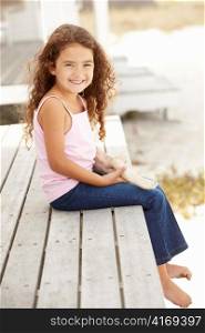 Little girl outdoors holding starfish