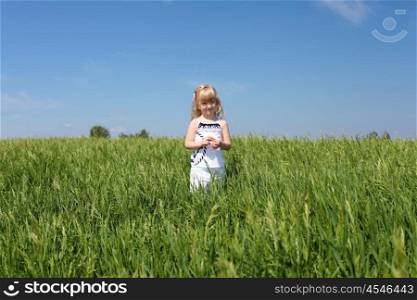 little girl outdoors in sunny summer day