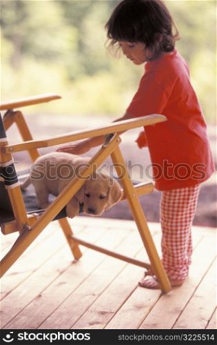 Little Girl Petting a Puppy