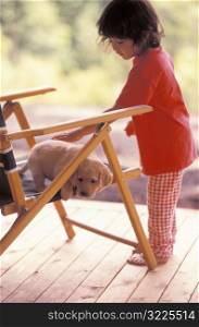 Little Girl Petting a Puppy