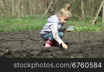 Little Girl Planting Peas on Smallholder Farm