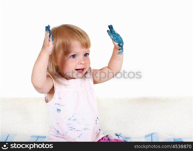Little girl playing and painting in studio