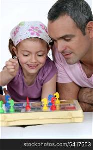 Little girl playing board game