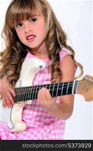 Little girl playing electric guitar