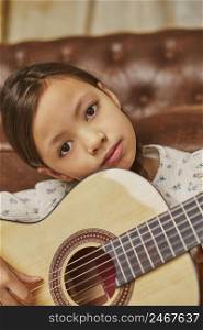 little girl playing guitar home 2