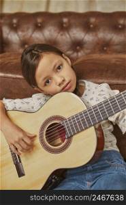 little girl playing guitar home 4