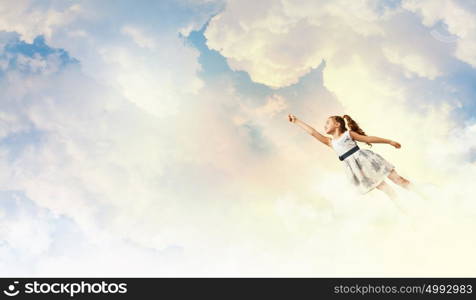 Little girl playing. Image of little pretty girl playing joyfully in the clouds