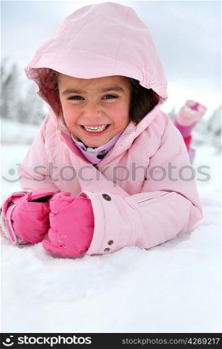 Little girl playing in the snow