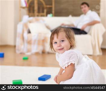 little girl playing on the floor at home