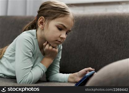little girl playing smartphone home
