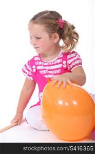 Little girl playing with balloon