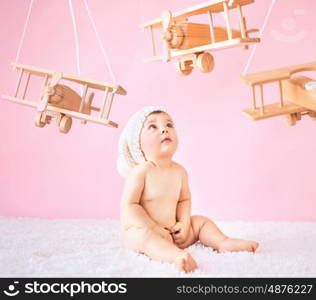 Little girl playing wooden toy planes