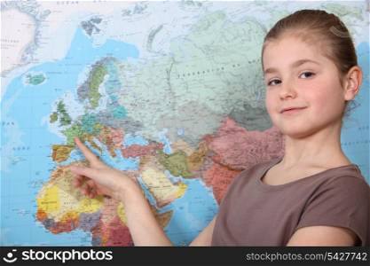 little girl pointing at a map