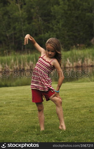 Little girl posing in a field