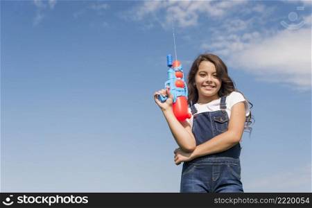 little girl posing with water gun