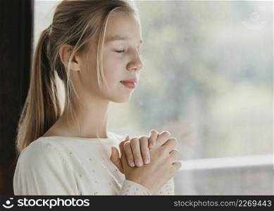 little girl praying with copy space