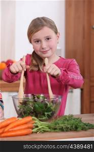 Little girl preparing salad