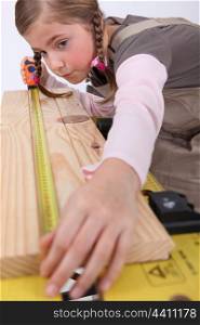Little girl pretending to be carpenter