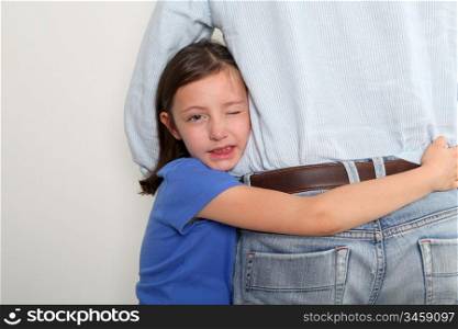 Little girl putting arms around her father&acute;s waist