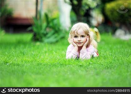 little girl relaxing on grass
