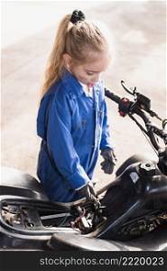 little girl repairing bike with spanner