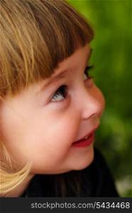 Little girl&rsquo;s face with hands and smile. Close up soft portrait on nature. Shalllow DOF. Focus on right eye