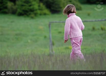 little girl running in nature